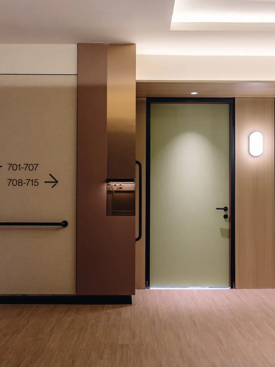 A wide corridor with sage doors