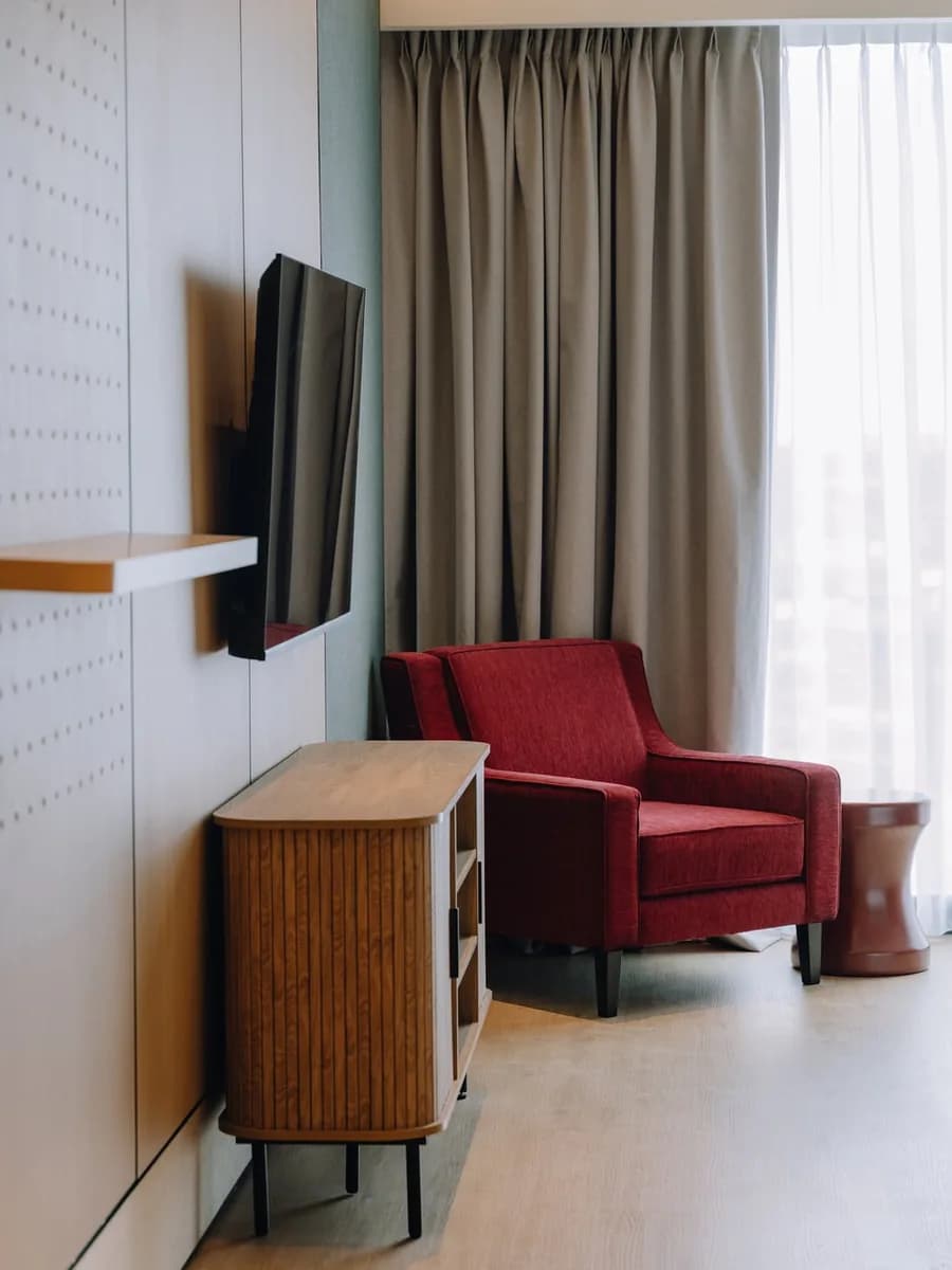 A warm shared lounge with a red armchair